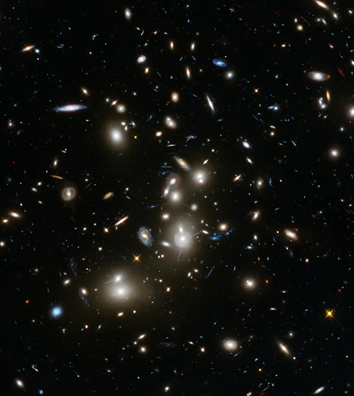 Image of a Cluster of Galaxies. Many elliptical and spiral galaxies are scattered throughout the image.