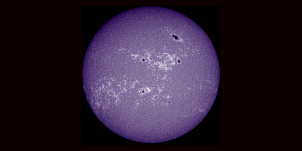 An image of the sun, showing plages as bright cloud-like regions.