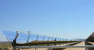 This photo depicts a long length of parabolic trough deflectors angled toward the sun.