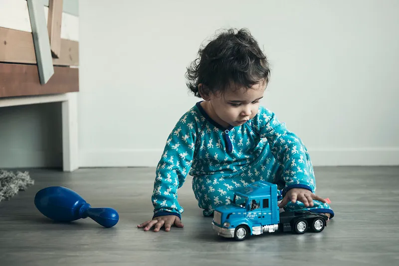 A baby playing with a toy.