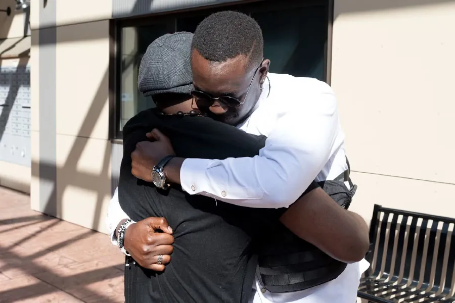 Two people embrace in a hug.