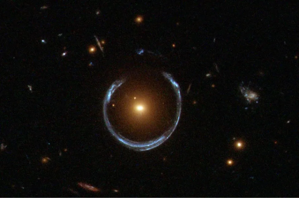 Photograph of a black sky. A yellow light is seen at the center. A circle of white light surrounds it.