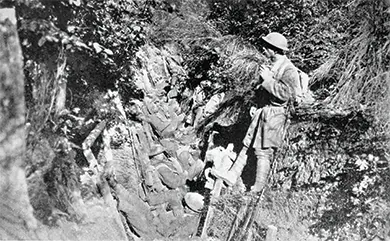 A photograph shows several U.S. soldiers sitting and standing in a trench.
