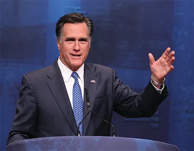 A photograph shows Mitt Romney speaking at a lectern.