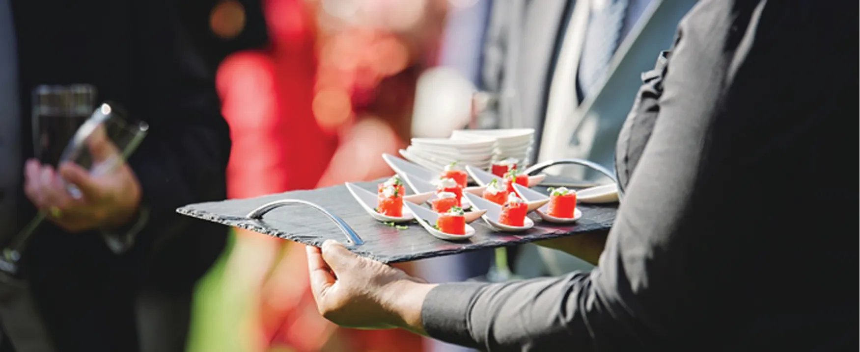 A photograph of a person holding a tray of food.