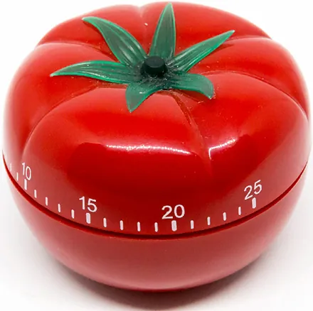 A Pomodoro kitchen timer, resembling a tomato with a scale marked on its body.