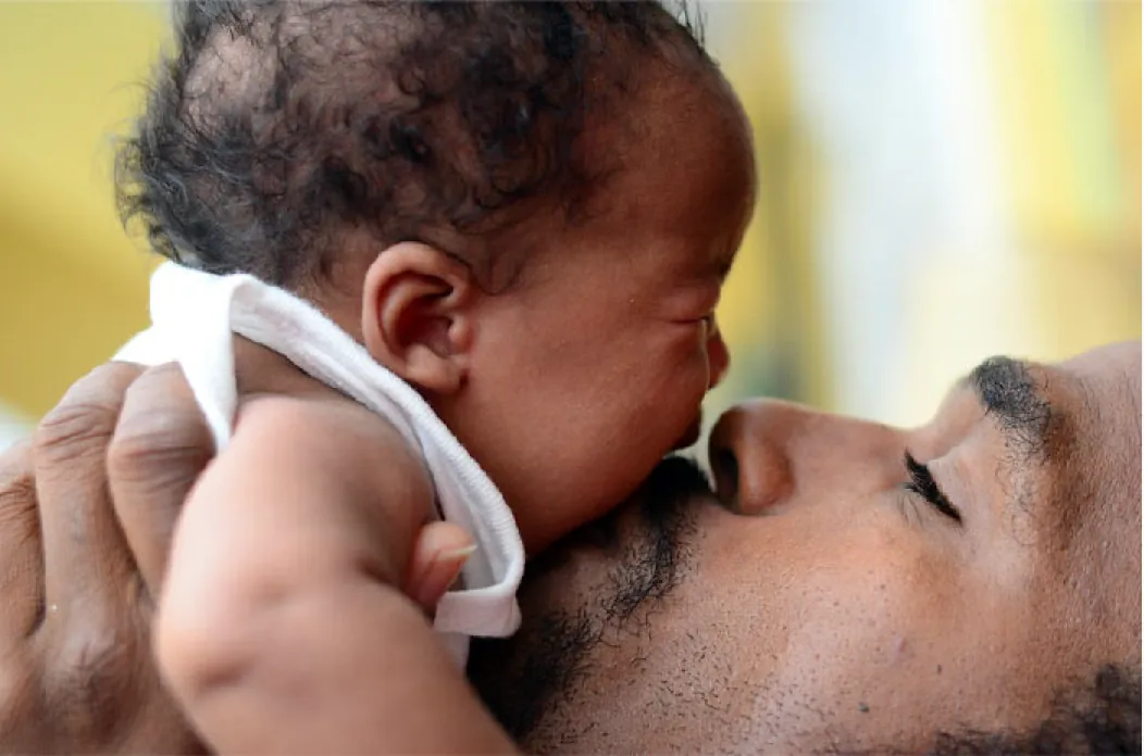 Adult holding crying infant.