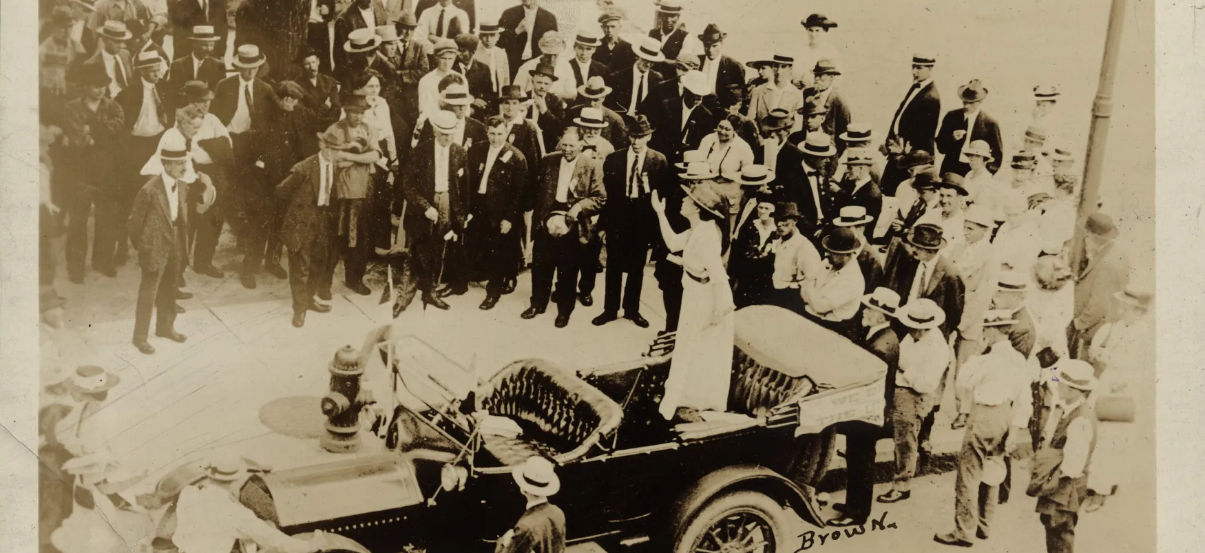 Suffragist Elsie Hill, who lived from 1883 to 1970, speaks forcefully from the backseat of a car in St. Paul, Minnesota, on July 1916, to a large group of people gathered around her.
