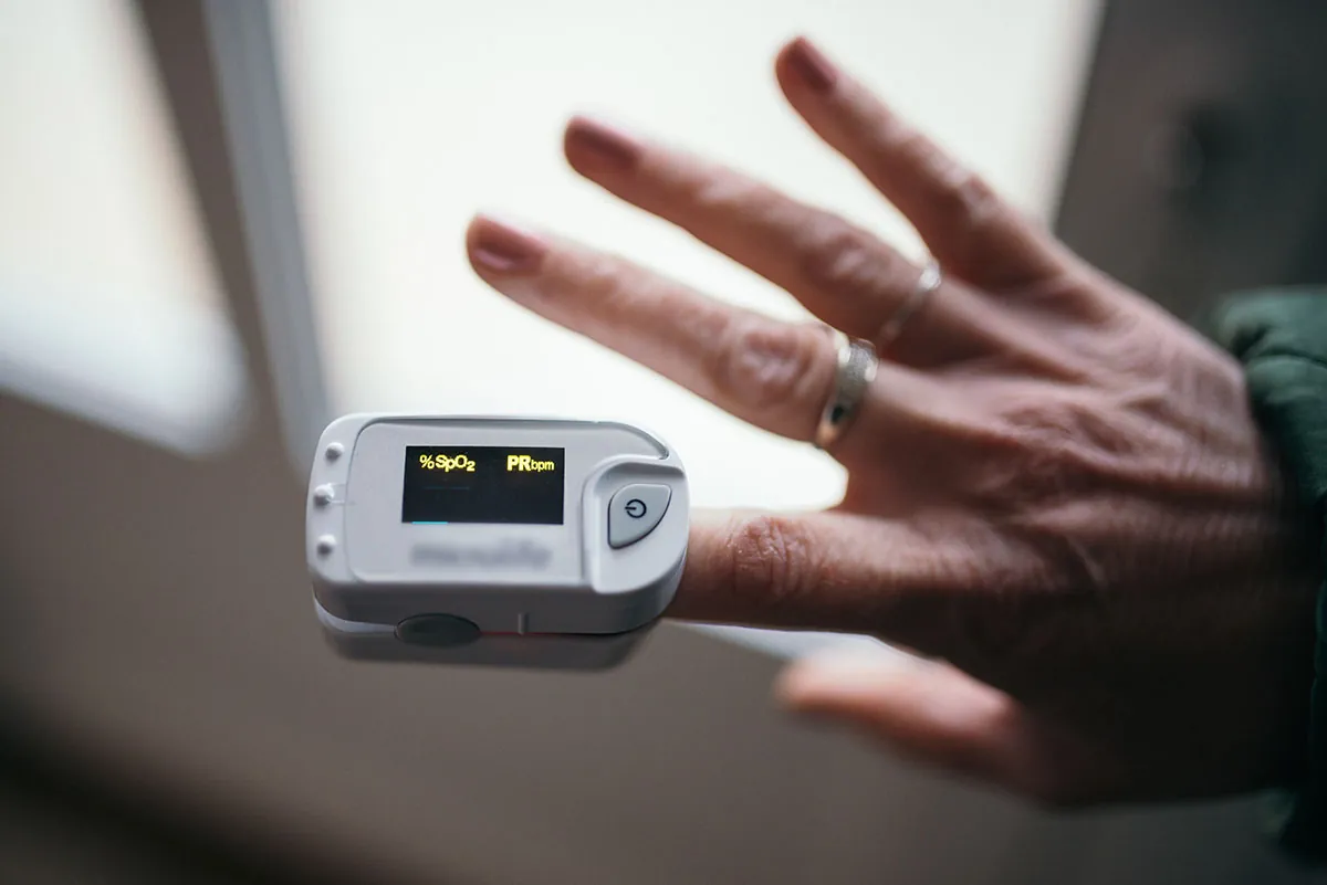 Pulse oximeter on patient’s finger.