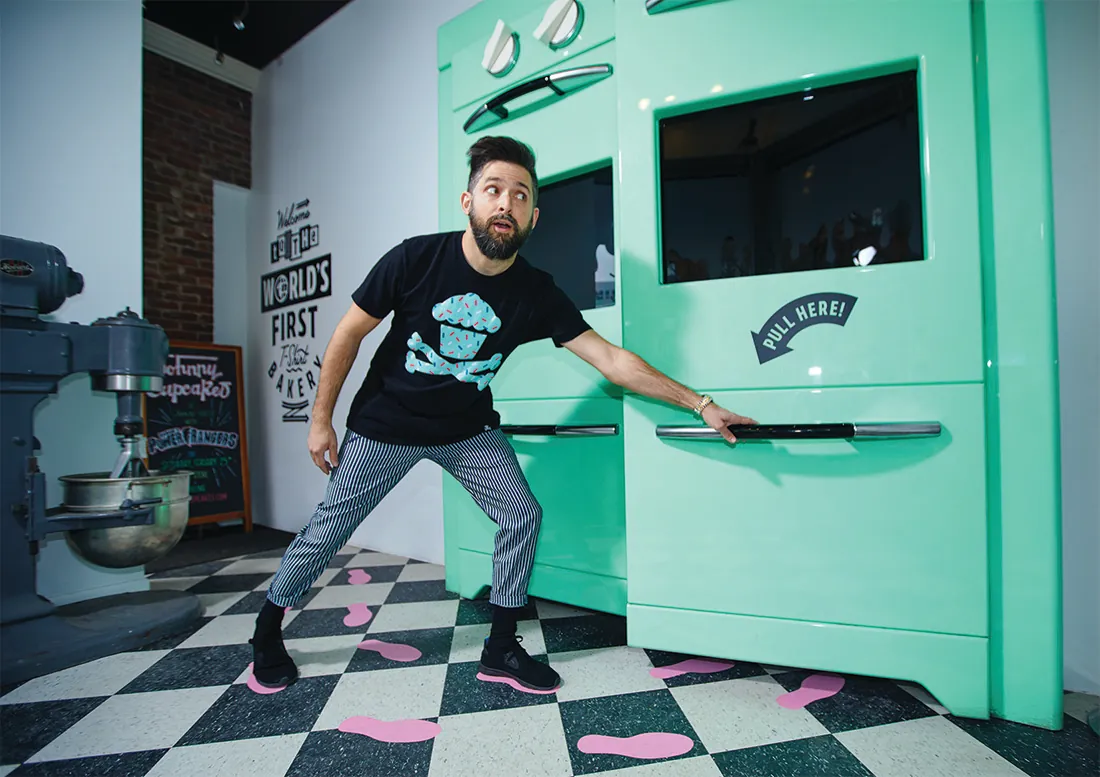 Photo of Johnny Earl with his cupcake t-shirts.