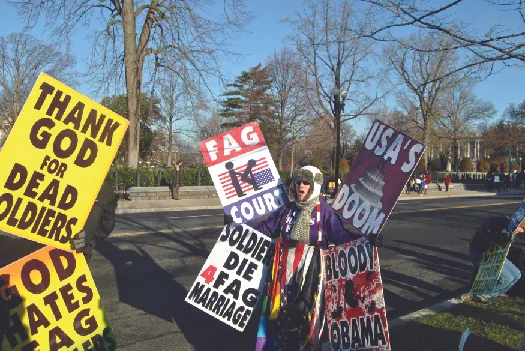 A photo of people holding signs. The signs read “Thank God for dead soldiers”, “God hates—”, “Fag Court”, “Soldiers die 4 fag marriage”, “USA’s doom,” and “Bloody Obama”.