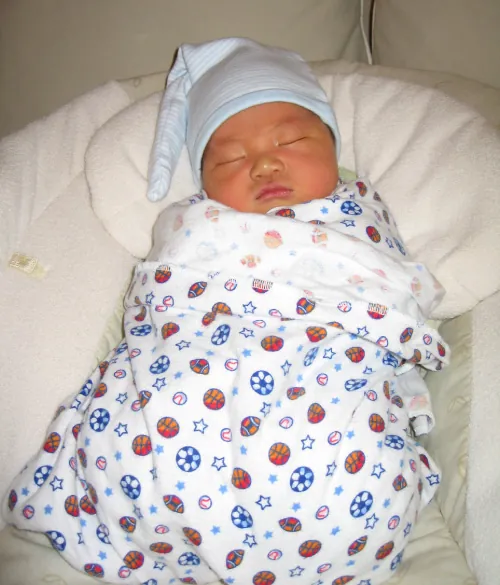 Infant swaddled in a blanket.
