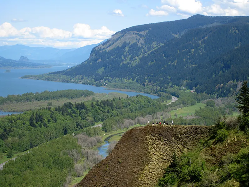 Aerial view of amountainous area with a river winding through it.