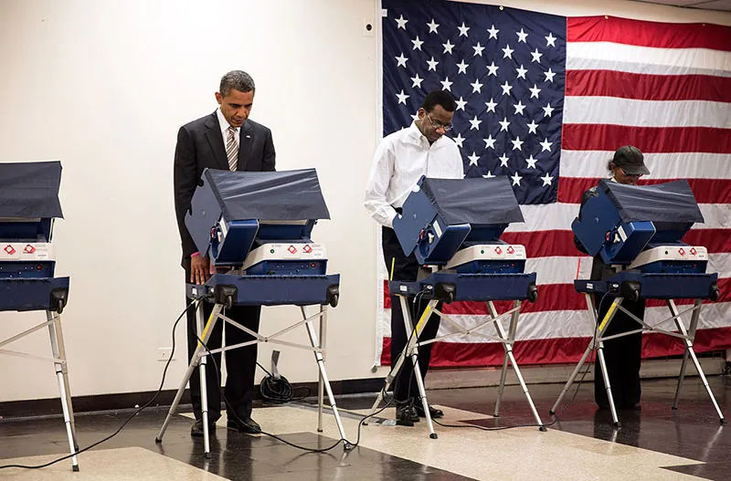 A photo shows a man, a woman, and President Obama casting their vote.