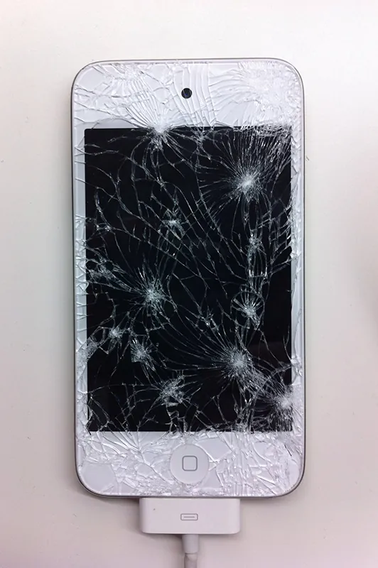 A photo shows an overhead view of an iPhone with shattered screen.