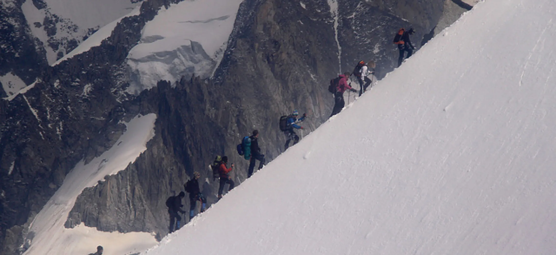 This photo shows a group of people climbing a mountain.