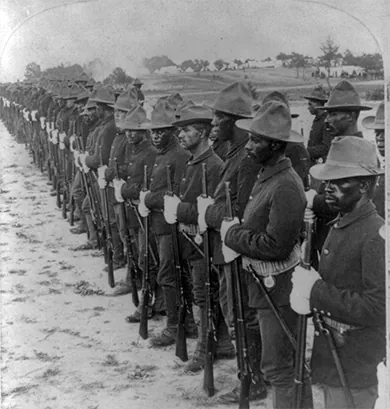 A photograph depicts a line of Black soldiers in the Spanish-American War.