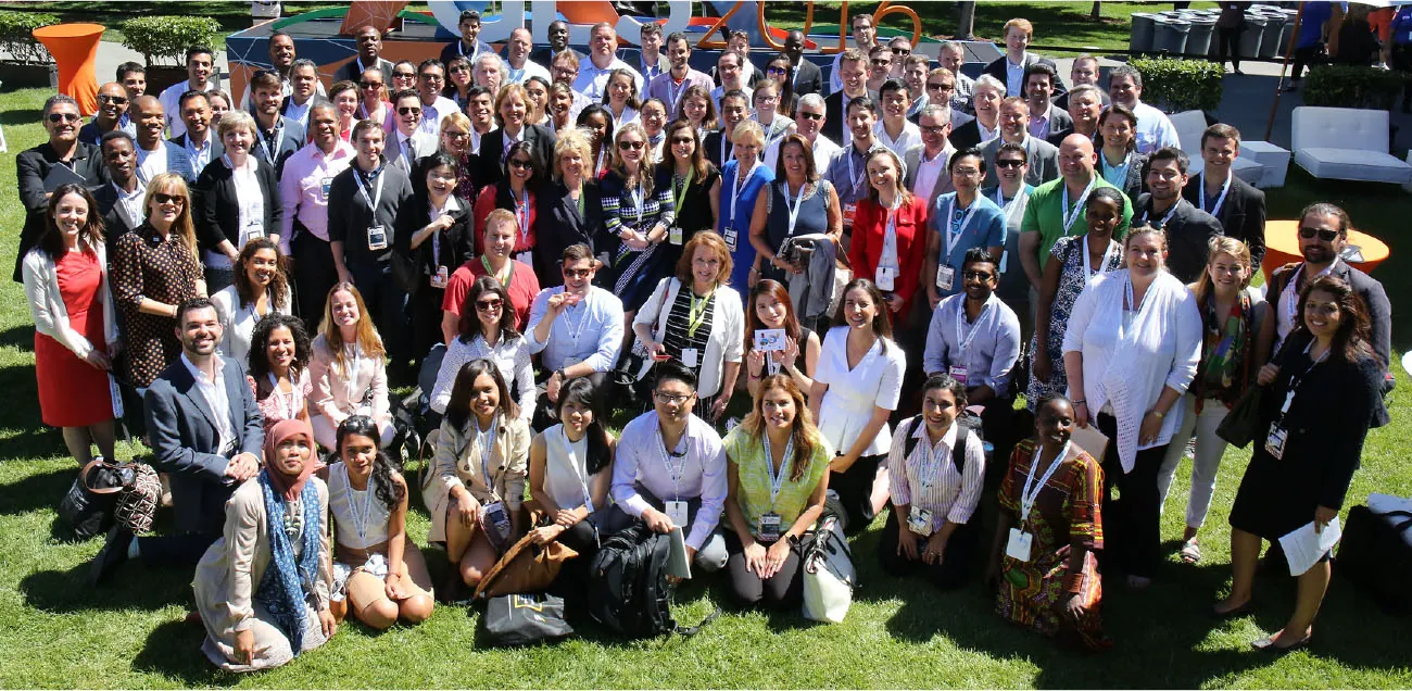 Photo of large group of individuals from different ethnicities standing outside together.