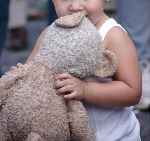 A child holds a stuffed animal