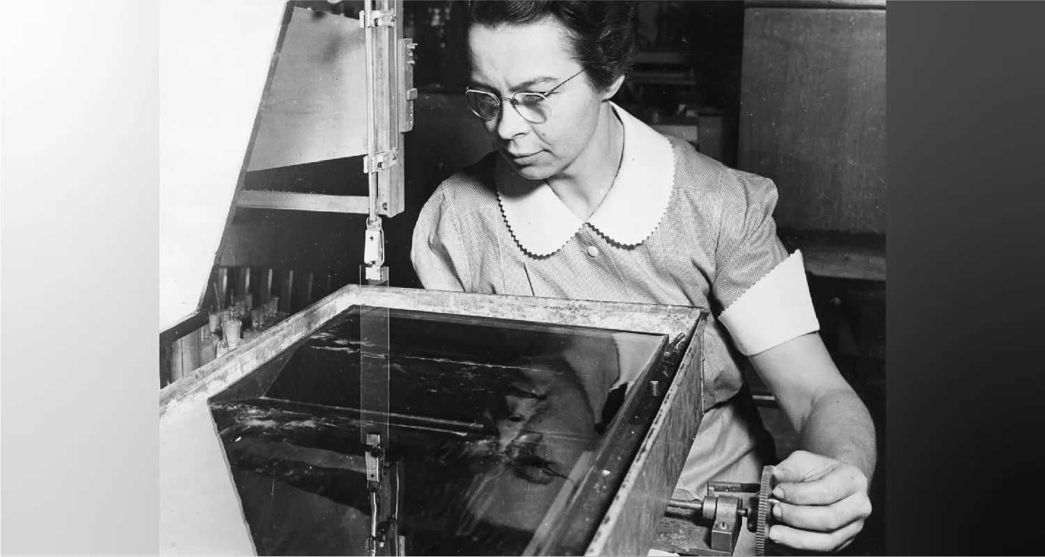 Katharine Burr Blodgett using equipment.