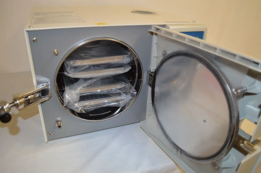 A photograph shows a autoclave with the door open.