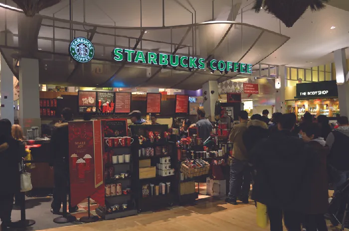 A picture of the inside of a Starbucks store showing shelves of items for sale.