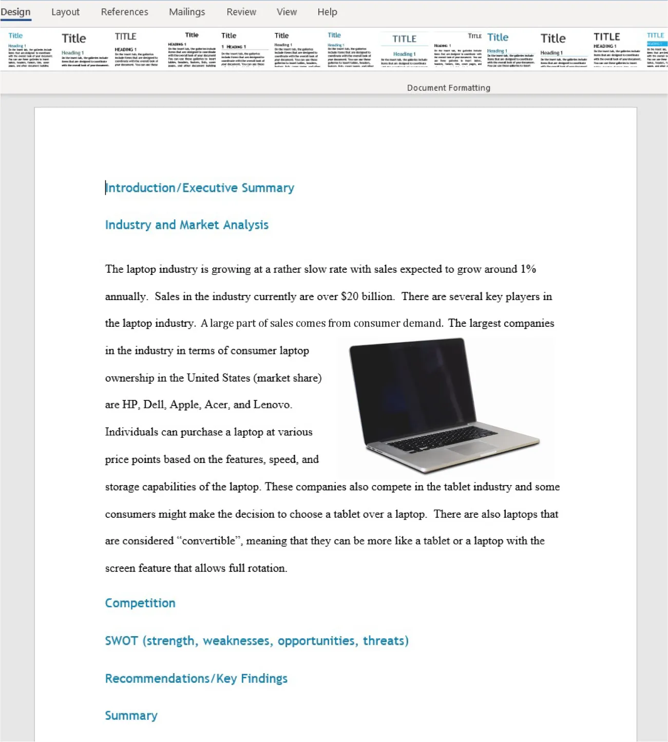 Design tab is selected. Various themes show in toolbar. Document visible with headings bolded in larger blue font; text in regular-sized, black font. Image of a computer inserted to right of text.