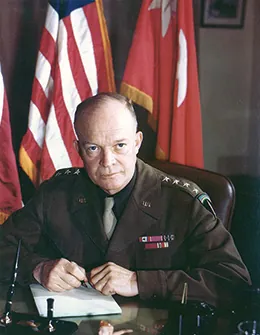 A photograph shows Dwight Eisenhower seated at a desk in his military uniform.