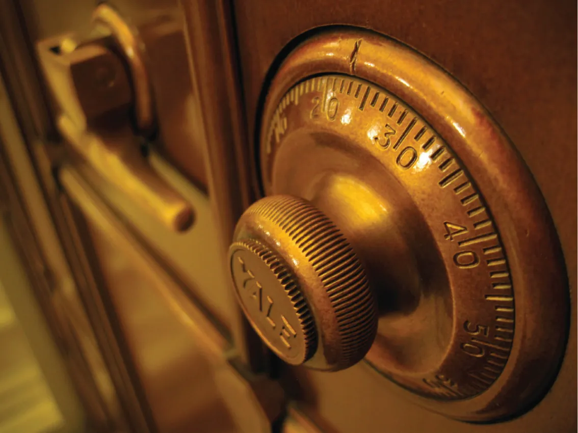 A combination lock on a vault door.