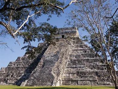 A photograph shows El Castillo, a stepped pyramid with a set of wide stone steps running up the front and a square structure with an entryway on top.