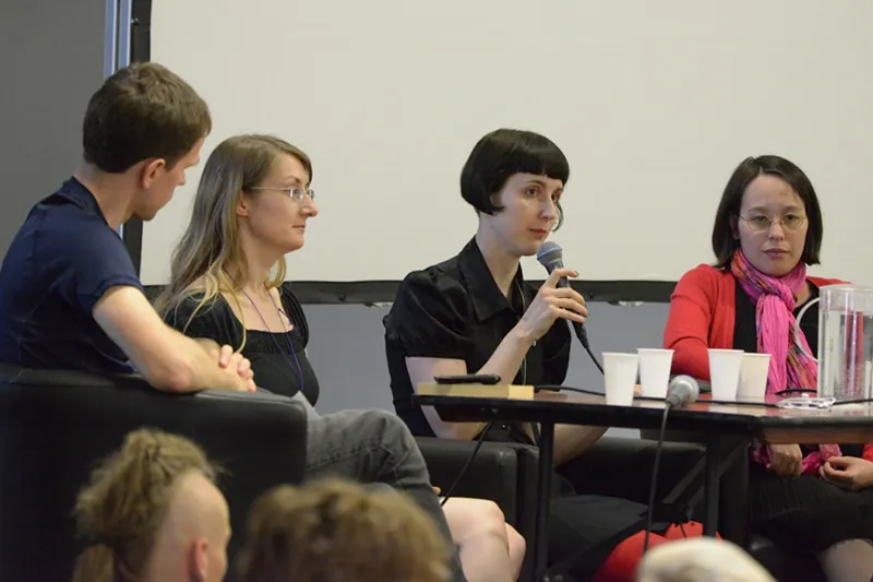 Four students from different countries sit in a classroom, while attending a foreign language conference at Finncon in 2013.