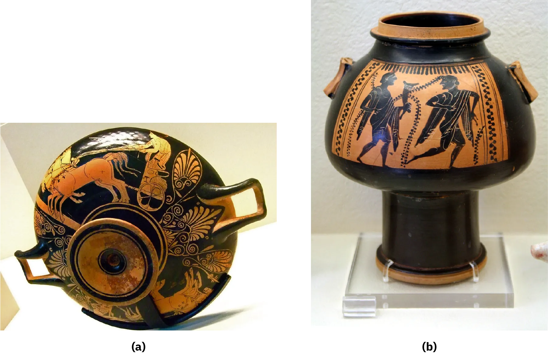 A picture of an ancient cup and a jug are shown. (a) An image of a black and orange cup on its side with the bottom facing forward is shown. The bottom of the cup has orange and black circles and sticks out the bottom of the cup. The outside of the cup is black with an orange scene depicted twice – two horses pulling a standing chariot with a rider holding the reins. In between are designs depicting leaf-like drawings. Two handles are shown, one on each side. (b) A tall black jug is shown with orange drawings on the top. The top is a circular orange-lipped opening with a thicker middle with two orange handles and a thinner tall base. The larger part shows an orange drawing of two figures – both in long cloths and barefoot with muscular legs. The figure on the left holds a cone shaped object in their left hand and the figure on the right appears to be running away. Repetitive circular resigns run along both sides of the drawing and long leafy vines are shown around the figures.