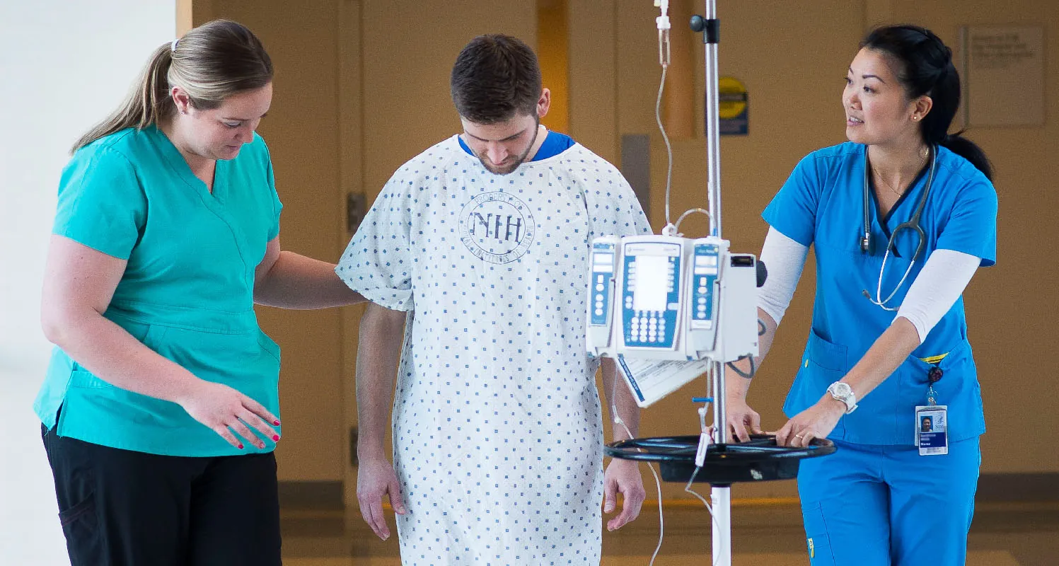 Healthcare workers assisting a patient.