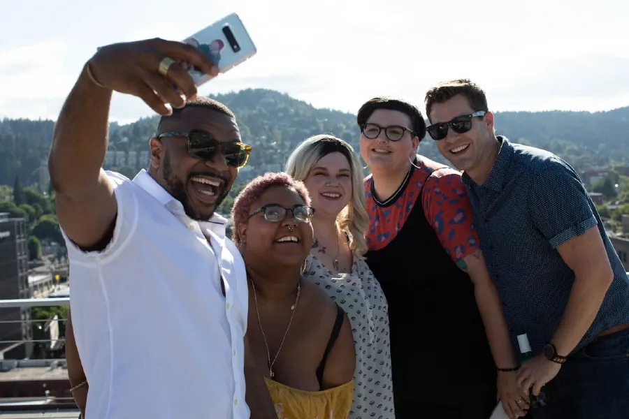 Group of adults taking a selfie.