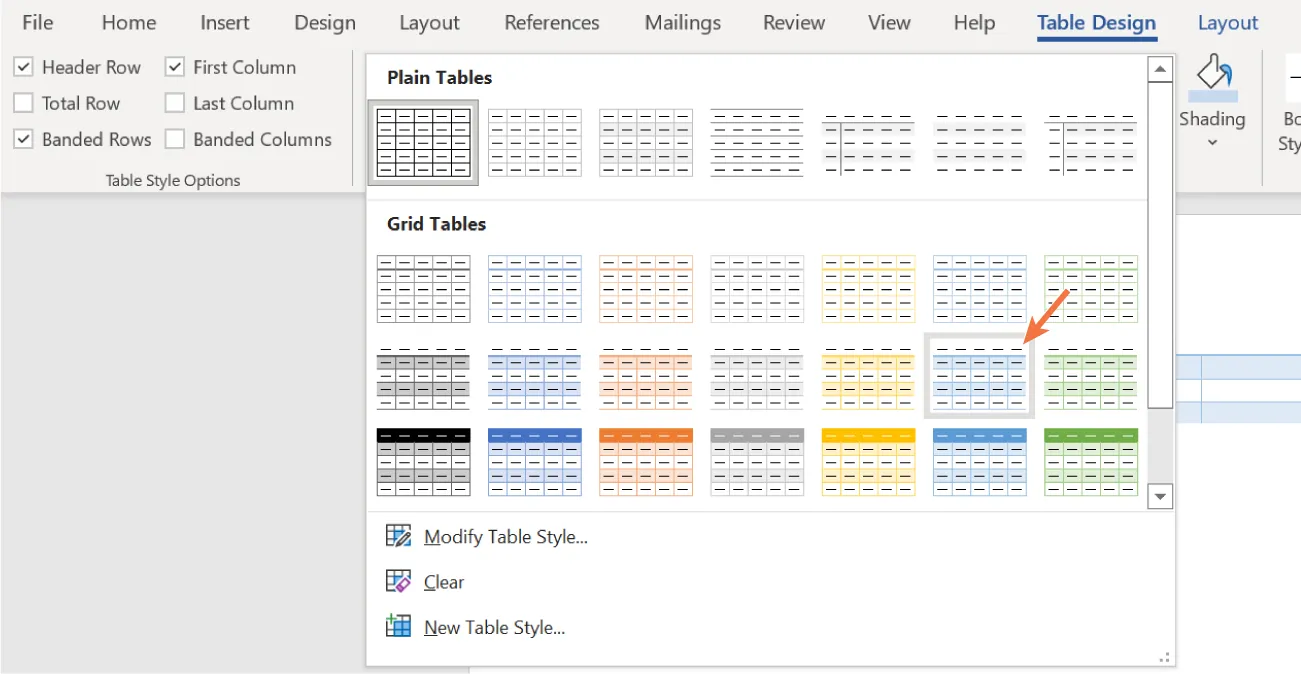 Table Styles command group displays options for Plain Tables, Grid Tables, Modify Table Style, Clear, New Table Style. In Grid Tables, a selected table displays information centered amid alternating blue/white rows.