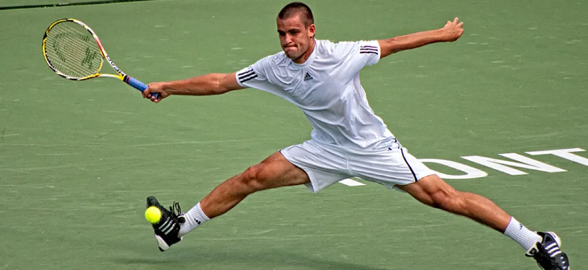 This photograph shows a man playing tennis.