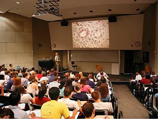 A photograph shows students in a classroom.