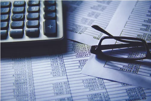 Photo of a calculator and spreadsheets.