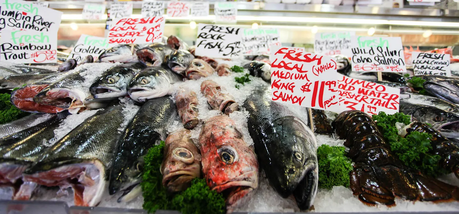 Different varieties of fish with their name tags for sale.