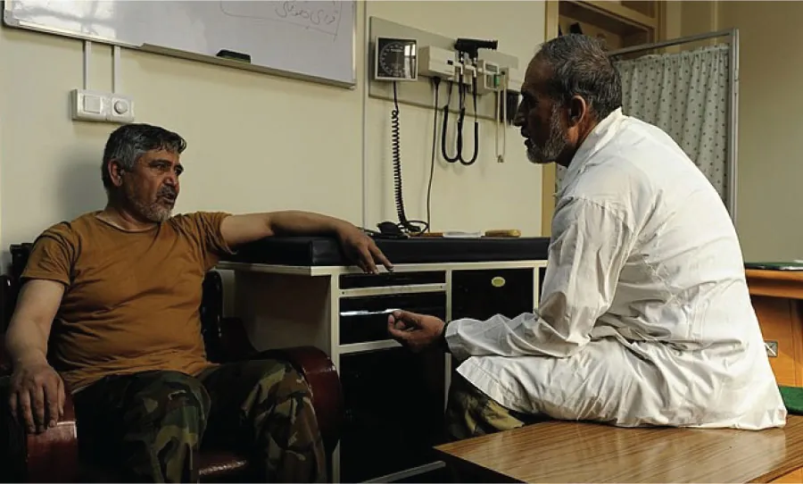 An older adult has a conversation with a health-care professional.