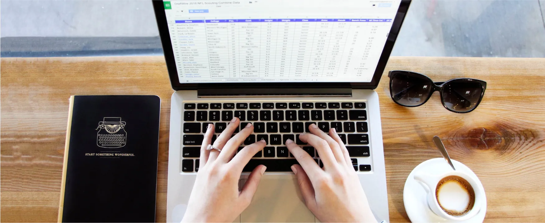 A person works on a spreadsheet on a laptop.