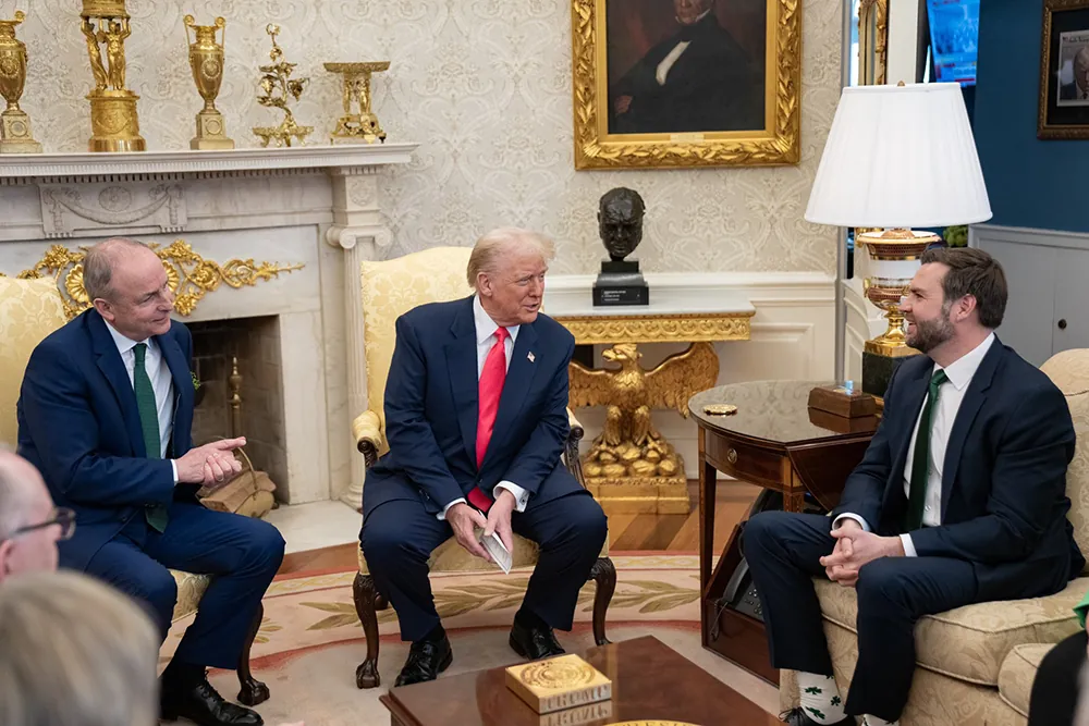 A photo shows the the leader of Ireland and the President of the United States seated next to each other on chairs in the Oval Office. And Vice President JD Vance seated on a sofa close to them.