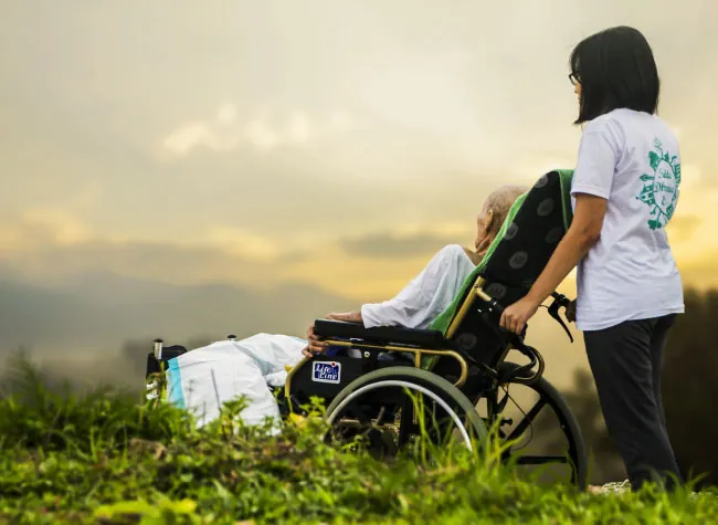 A person uses a walker as they cross a street in a crosswalk.
