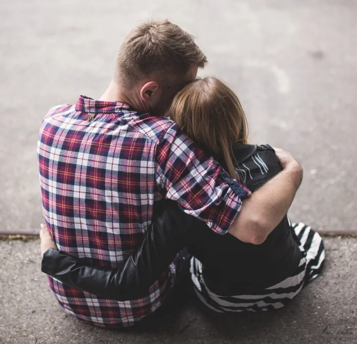 Photo of two adolescents hugging each other.