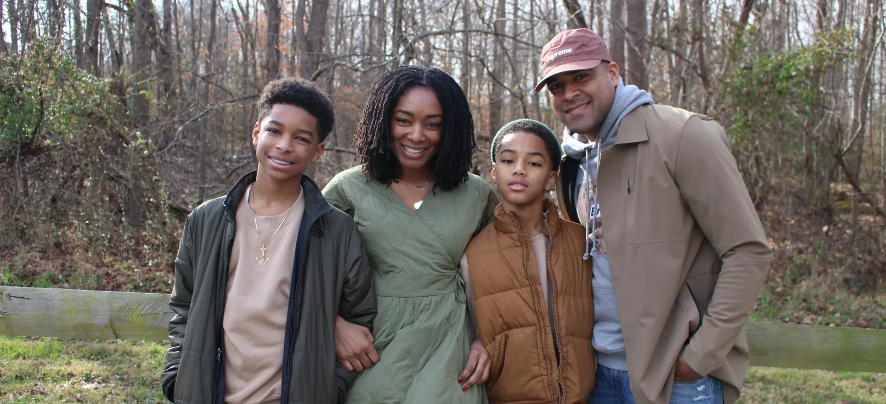 Photo of two adults with two adolescents outside.