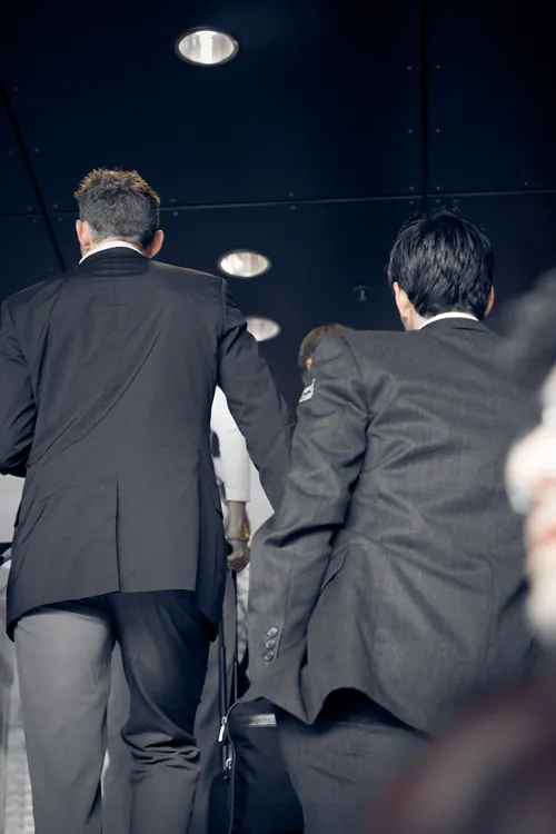 Figure (b) shows a group of businessmen.