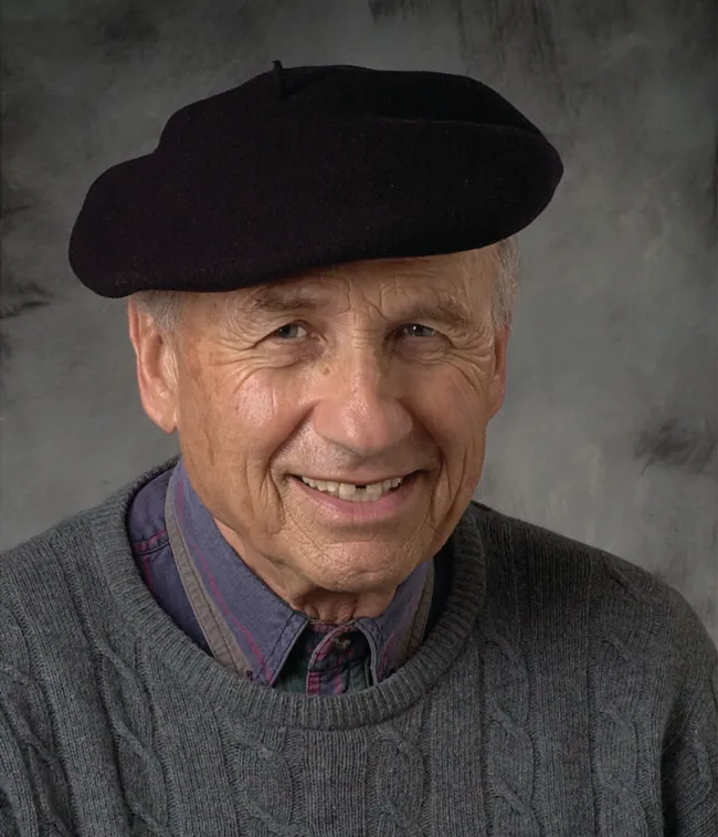 A photograph of Walter Kohn is shown.