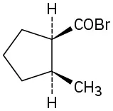 The structure of cis-2-methylcyclopentanecarbonyl bromide shows a cyclopentane ring with a methyl group drawn as a wedge on one carbon and a carbonyl group on the next carbon of the ring, drawn as a wedge. Also attached to the carbonyl group is a bromine atom.