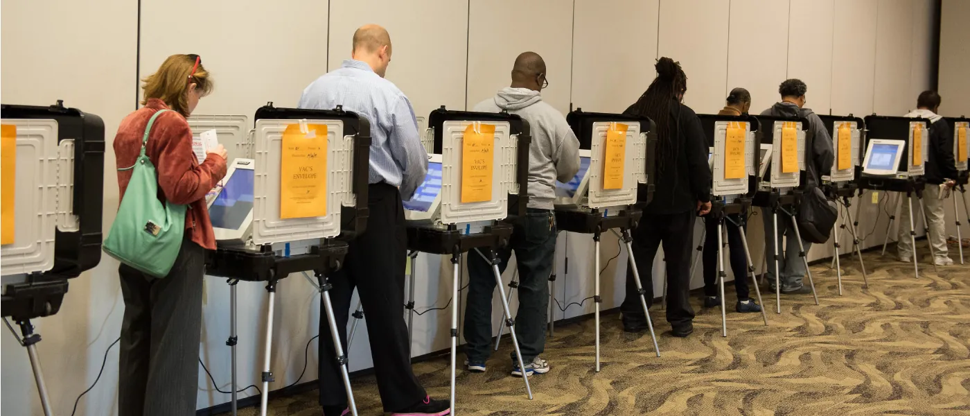 Several people are casting their vote in polling booths.