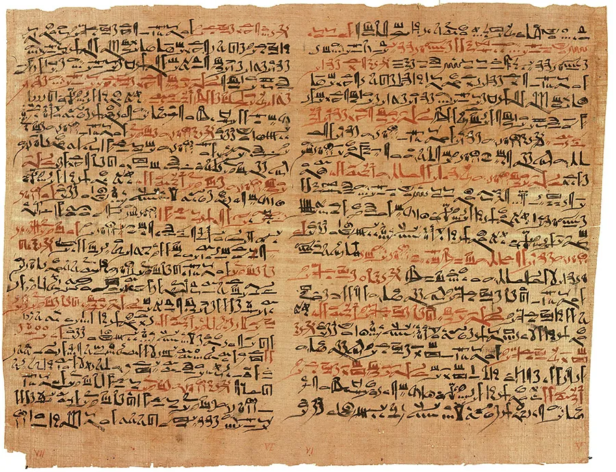 An old piece of paper has writing in an ancient language on it.